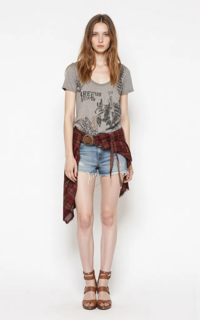 A French female model wearing Rustic   style clothing, against a white background, in a front   facing shot focusing on shoes